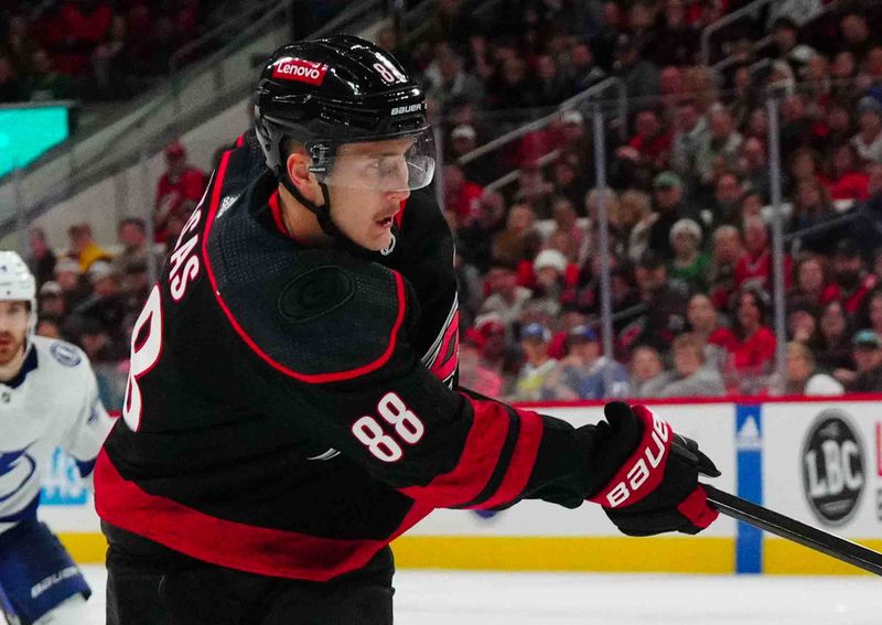 Nov 24, 2023; Raleigh, North Carolina, USA; Carolina Hurricanes center Martin Necas (88) takes a shot against the Tampa Bay Lightning during the first period at PNC Arena. Mandatory Credit: James Guillory-USA TODAY Sports