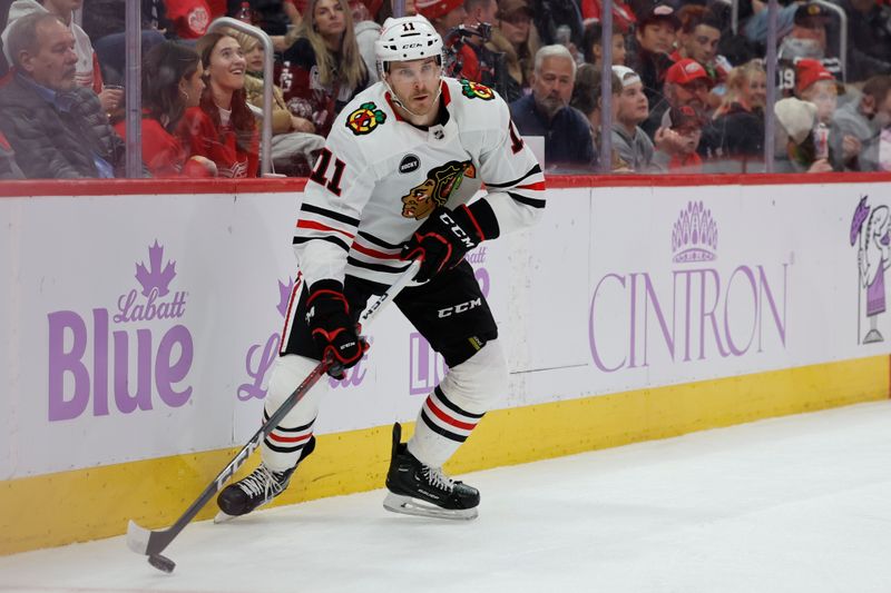 Nov 30, 2023; Detroit, Michigan, USA;  Chicago Blackhawks right wing Taylor Raddysh (11) skates with the puck in the first period against the Detroit Red Wings at Little Caesars Arena. Mandatory Credit: Rick Osentoski-USA TODAY Sports