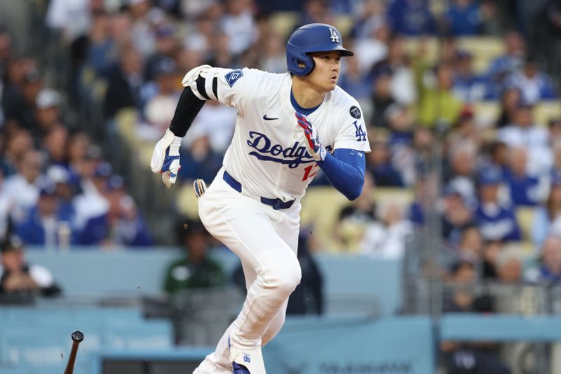 Apr 28, 2025; Los Angeles, California, USA; Los Angeles Dodgers two-way player Shohei Ohtani (17) hits a single in the first inning against the Miami Marlins during the first inning at Dodger Stadium. Mandatory Credit: Jason Parkhurst-Imagn Images