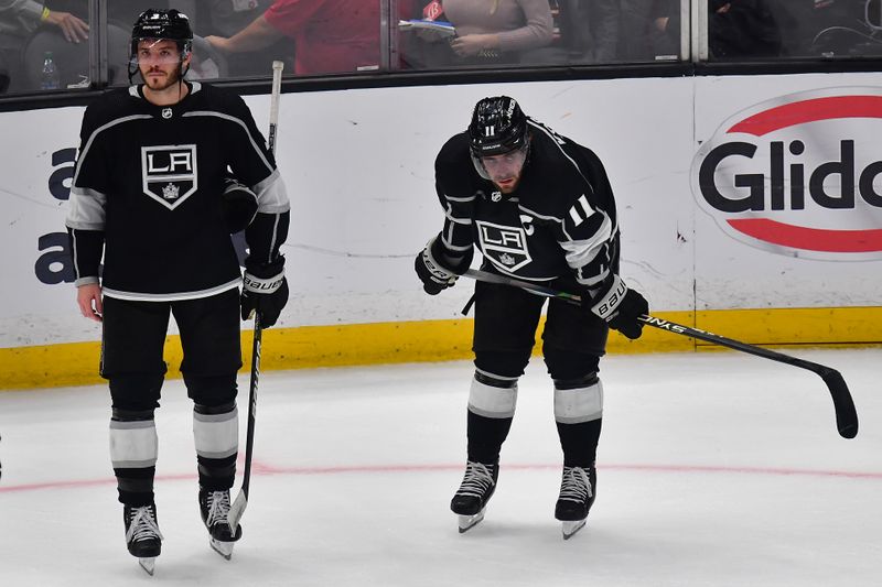 Apr 29, 2023; Los Angeles, California, USA; Los Angeles Kings defenseman Matt Roy (3) and center Anze Kopitar (11) react following the loss against the Edmonton Oilers in game six of the first round of the 2023 Stanley Cup Playoffs at Crypto.com Arena. Mandatory Credit: Gary A. Vasquez-USA TODAY Sports