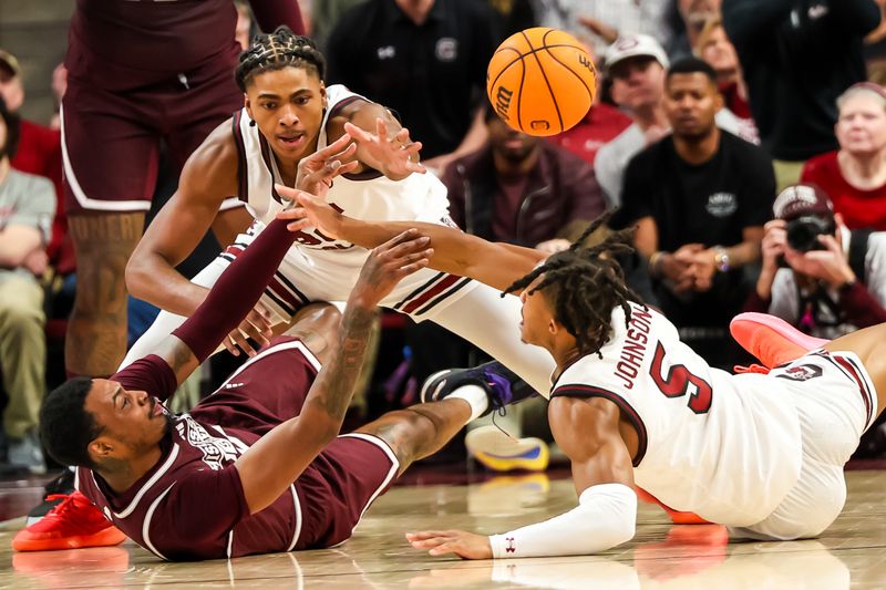 Jan 6, 2024; Columbia, South Carolina, USA; Mississippi State Bulldogs forward D.J. Jeffries (0), South Carolina Gamecocks forward Collin Murray-Boyles (30) and guard Meechie Johnson (5) battle for the ball in the first half at Colonial Life Arena. Mandatory Credit: Jeff Blake-USA TODAY Sports