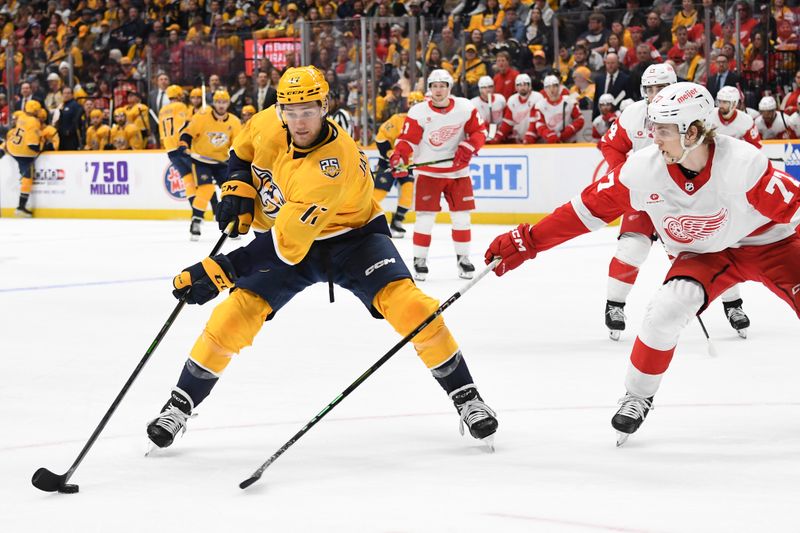 Mar 23, 2024; Nashville, Tennessee, USA; Nashville Predators center Mark Jankowski (17) handles the puck against Detroit Red Wings defenseman Simon Edvinsson (77) during the third period at Bridgestone Arena. Mandatory Credit: Christopher Hanewinckel-USA TODAY Sports