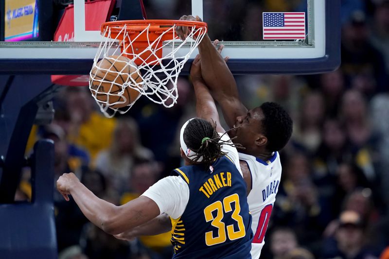 INDIANAPOLIS, INDIANA - FEBRUARY 22: Jalen Duren #0 of the Detroit Pistons dunks the ball past Myles Turner #33 of the Indiana Pacers in the second quarter at Gainbridge Fieldhouse on February 22, 2024 in Indianapolis, Indiana. NOTE TO USER: User expressly acknowledges and agrees that, by downloading and or using this photograph, User is consenting to the terms and conditions of the Getty Images License Agreement. (Photo by Dylan Buell/Getty Images)