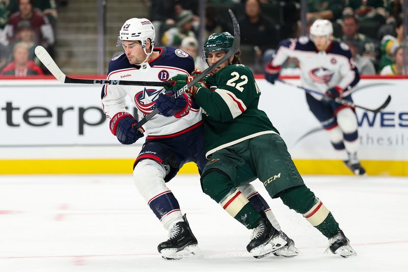 Oct 10, 2024; Saint Paul, Minnesota, USA; Columbus Blue Jackets center Sean Monahan (23) and Minnesota Wild center Marat Khusnutdinov (22) collide during the third period at Xcel Energy Center. Mandatory Credit: Matt Krohn-Imagn Images