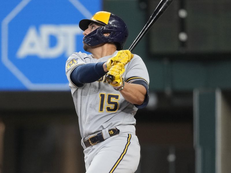 Aug 20, 2023; Arlington, Texas, USA; Milwaukee Brewers right fielder Tyrone Taylor (15) follows through on his two-run triple against the Texas Rangers during the eighth inning at Globe Life Field. Mandatory Credit: Jim Cowsert-USA TODAY Sports