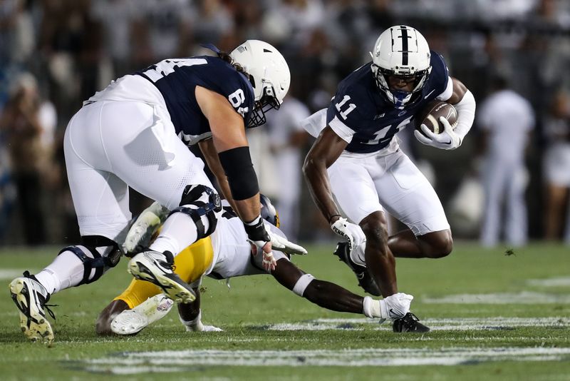 Sep 2, 2023; University Park, Pennsylvania, USA; Penn State Nittany Lions wide receiver Malik McClain (11) runs with the ball while trying to avoid a tackle during the second quarter against the West Virginia Mountaineers at Beaver Stadium. Penn State defeated West Virginia 38-15. Mandatory Credit: Matthew O'Haren-USA TODAY Sports