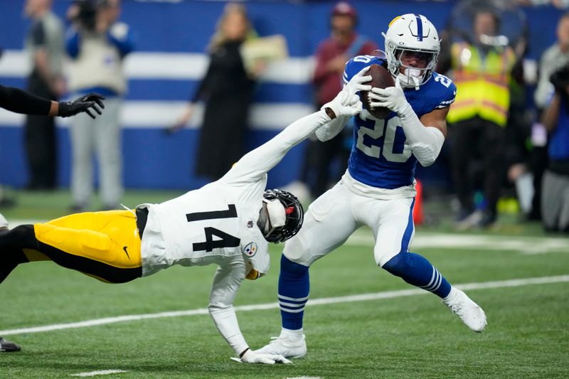 Indianapolis Colts safety Nick Cross (20) intercepts a pass intended for Pittsburgh Steelers wide receiver George Pickens (14) during the first half of an NFL football game in Indianapolis Saturday, Dec. 16, 2023. (AP Photo/Michael Conroy)