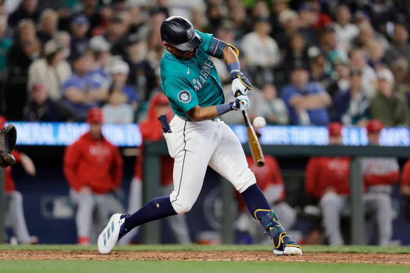 Jun 1, 2024; Seattle, Washington, USA;  Seattle Mariners center fielder Julio Rodríguez (44) hits a single against the Los Angeles Angels during the sixth inning at T-Mobile Park. Mandatory Credit: John Froschauer-USA TODAY Sports