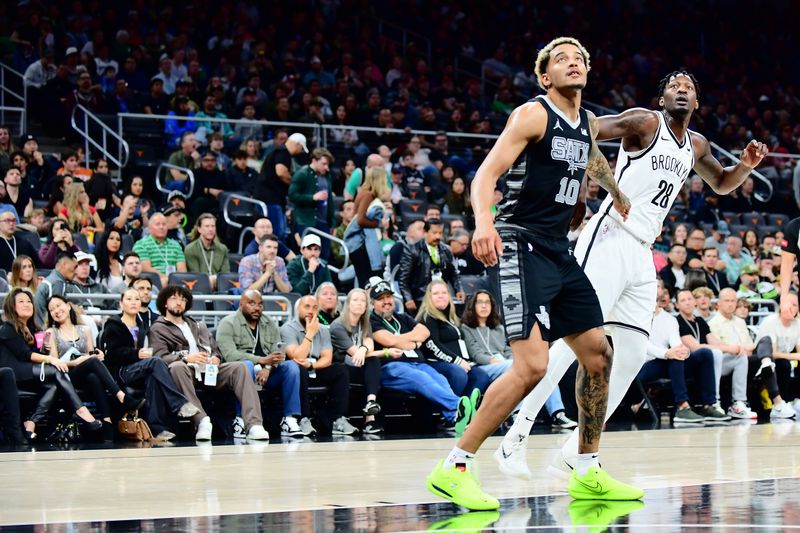 AUSTIN, TX - MARCH 17: Jeremy Sochan #10 of the San Antonio Spurs and Dorian Finney-Smith #28 of the Brooklyn Nets box out during the game on March 17, 2024 at the Moody Center in Austin, Texas. NOTE TO USER: User expressly acknowledges and agrees that, by downloading and or using this photograph, user is consenting to the terms and conditions of the Getty Images License Agreement. Mandatory Copyright Notice: Copyright 2024 NBAE (Photos by Michael Gonzales/NBAE via Getty Images)