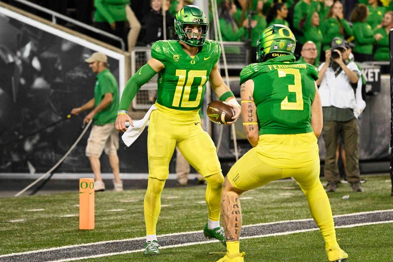 Oct 1, 2022; Eugene, Oregon, USA; Oregon Ducks quarterback Bo Nix (10) celebrates scoring a touchdown with teammate tight end Terrance Ferguson (3) during the second half at Autzen Stadium. The Ducks won the game 45-27. Mandatory Credit: Troy Wayrynen-USA TODAY Sports