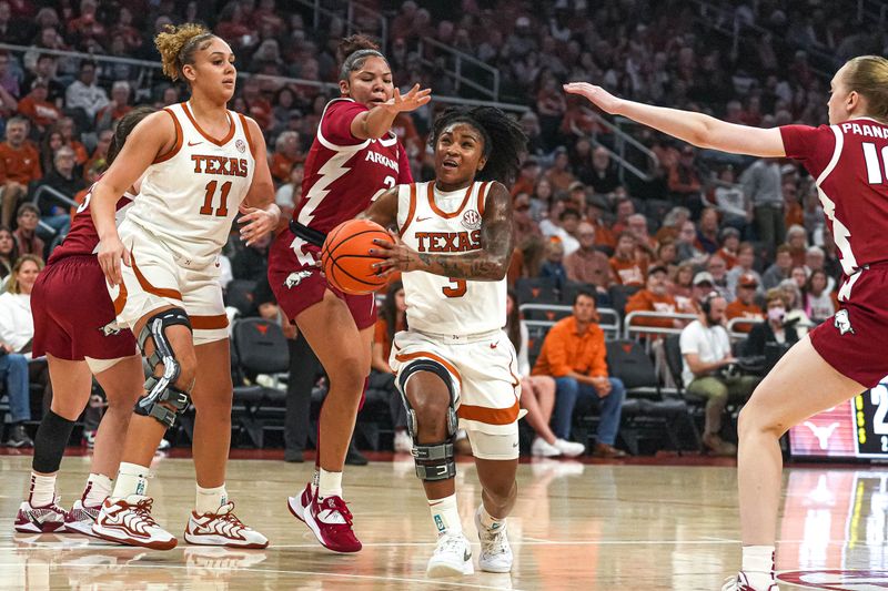 Jan 5, 2025; Austin, Texas, USA; Texas Longhorns guard Rori Harmon (3) pushes past Arkansas guard Kiki Smith (2) during the game at Moody Center. Mandatory Credit: Aaron E. Martinez/USA TODAY Network via Imagn Images