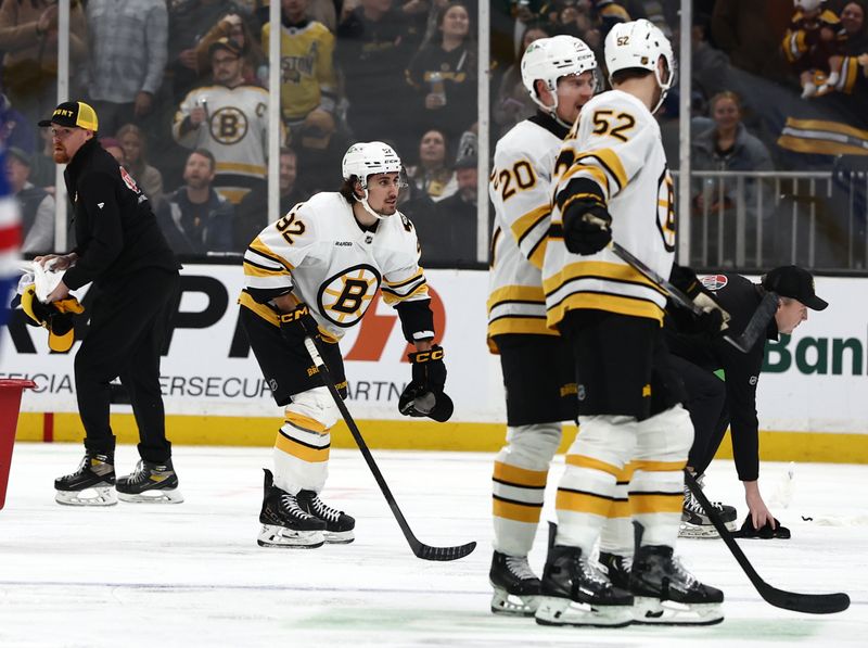 Jan 10, 2026; Boston, Massachusetts, USA; Boston Bruins center Marat Khusnutdinov (92) picks up a hat off the ice after scoring his third goal of the game during the third period against the New York Rangers at TD Garden. Mandatory Credit: Winslow Townson-Imagn Images