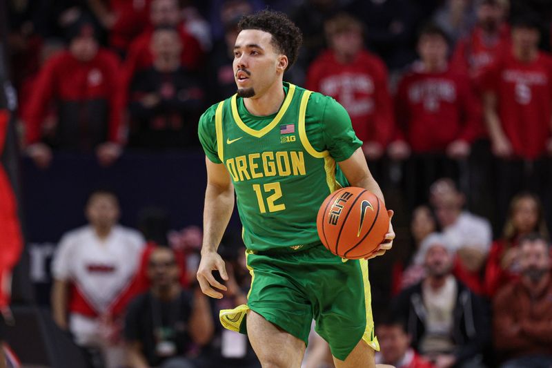 Jan 5, 2026; Piscataway, New Jersey, USA; Oregon Ducks guard Drew Carter (12) dribbles up court against the Rutgers Scarlet Knights during the first half at Jersey Mike's Arena. Mandatory Credit: Vincent Carchietta-Imagn Images