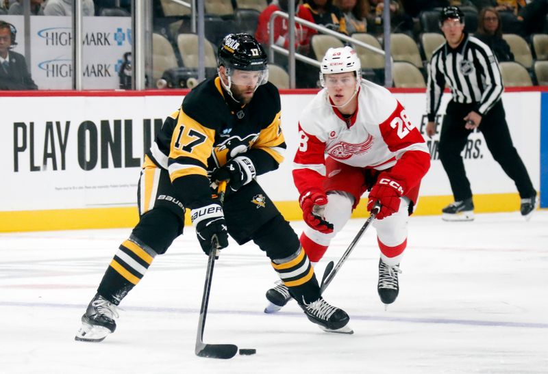 Oct 1, 2024; Pittsburgh, Pennsylvania, USA;  Pittsburgh Penguins right wing Bryan Rust (17) moves the puck against Detroit Red Wings right wing Michael Brandsegg-Nygård (28) during the first period at PPG Paints Arena. Mandatory Credit: Charles LeClaire-Imagn Images