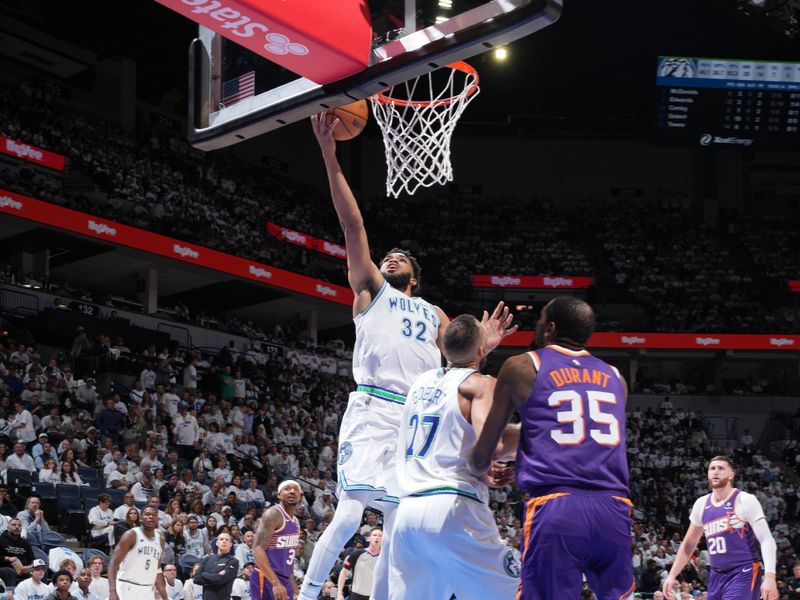 MINNEAPOLIS, MN -  APRIL 20: Karl-Anthony Towns #32 of the Minnesota Timberwolves drives to the basket during Round One Game One of the 2024 NBA Playoffs against the Phoenix Suns on April 20, 2024 at Target Center in Minneapolis, Minnesota. NOTE TO USER: User expressly acknowledges and agrees that, by downloading and or using this Photograph, user is consenting to the terms and conditions of the Getty Images License Agreement. Mandatory Copyright Notice: Copyright 2024 NBAE (Photo by Jordan Johnson/NBAE via Getty Images)