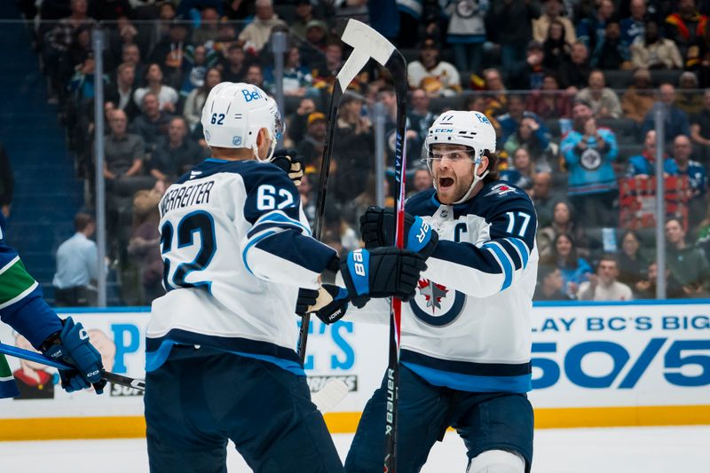 Nov 11, 2025; Vancouver, British Columbia, CAN;  Winnipeg Jets forward Nino Niederreiter (62) and forward Adam Lowry (17) celebrate Niederreiter’s goal against the Vancouver Canucks in the first period at Rogers Arena. Mandatory Credit: Bob Frid-Imagn Images