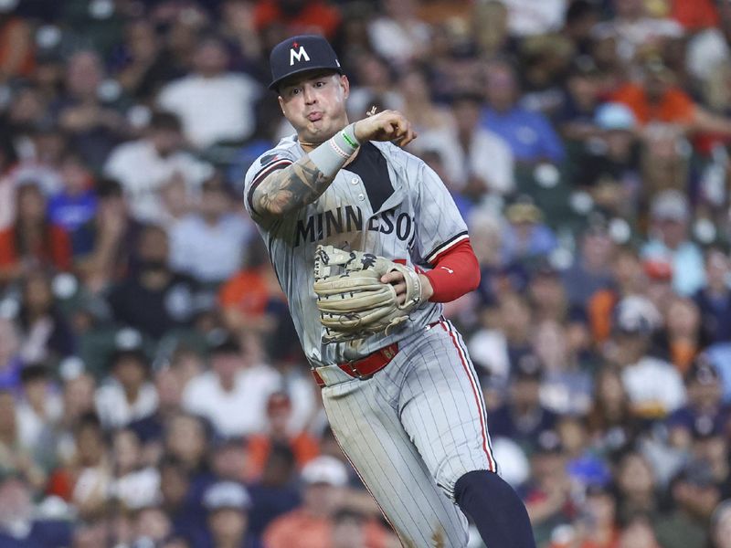 May 31, 2024; Houston, Texas, USA; Minnesota Twins third baseman Jose Miranda (64) throws out a runner at first base during the fourth inning against the Houston Astros at Minute Maid Park. Mandatory Credit: Troy Taormina-USA TODAY Sports