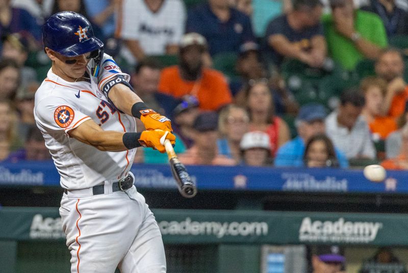 Jul 5, 2023; Houston, Texas, USA; Houston Astros second baseman Mauricio Dubon (14) hits a RBI double against the Colorado Rockies in the seventh inning at Minute Maid Park. Mandatory Credit: Thomas Shea-USA TODAY Sports