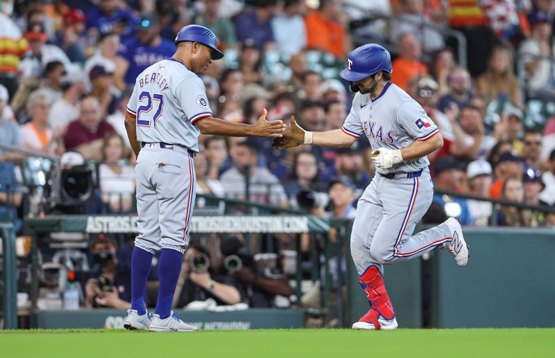 Jul 14, 2024; Houston, Texas, USA; Texas Rangers third baseman Josh Smith (8) celebrates with third base coach Tony Beasley (27) after hitting a home run during the first inning against the Houston Astros at Minute Maid Park. Mandatory Credit: Troy Taormina-USA TODAY Sports