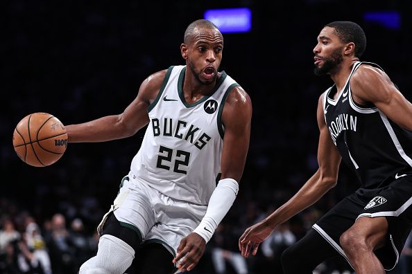 NEW YORK, NEW YORK - DECEMBER 27: Khris Middleton #22 of the Milwaukee Bucks is defended by Mikal Bridges #1 of the Brooklyn Nets during the first quarter of the game at Barclays Center on December 27, 2023 in New York City. NOTE TO USER: User expressly acknowledges and agrees that, by downloading and or using this photograph, User is consenting to the terms and conditions of the Getty Images License Agreement. (Photo by Dustin Satloff/Getty Images)