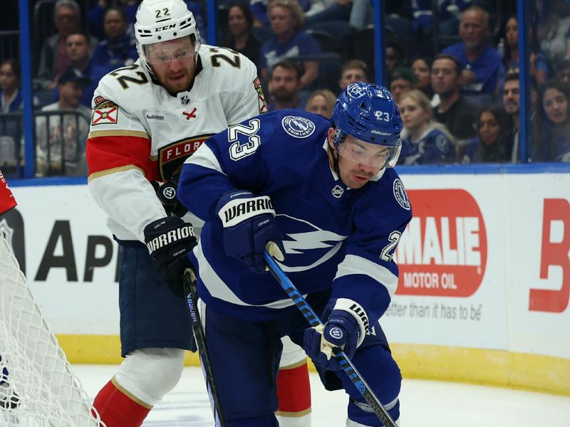 Oct 5, 2023; Tampa, Florida, USA; Tampa Bay Lightning center Michael Eyssimont (23) skates with the puck as Florida Panthers center Zac Dalpe (22) defends during the second period at Amalie Arena. Mandatory Credit: Kim Klement Neitzel-USA TODAY Sports