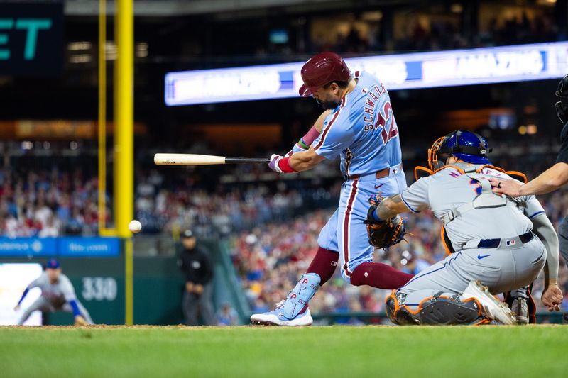 May 16, 2024; Philadelphia, Pennsylvania, USA; Philadelphia Phillies designated hitter Kyle Schwarber (12) hits an RBI double during the seventh inning against the New York Mets at Citizens Bank Park. Mandatory Credit: Bill Streicher-USA TODAY Sports