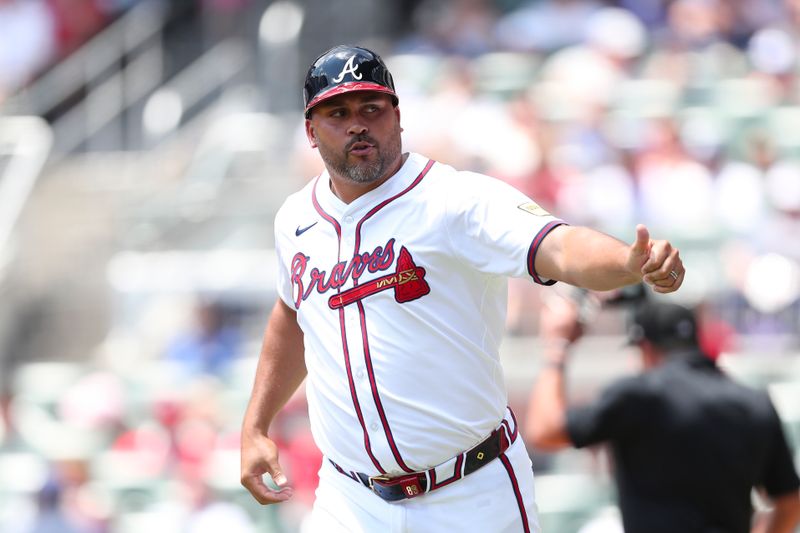 Aug 4, 2024; Cumberland, Georgia, USA; Atlanta Braves third base coach Matt Tuiasosopo (89) gives a thumbs up in a game  against the Miami Marlins in the first inning at Truist Park. Mandatory Credit: Mady Mertens-USA TODAY Sports