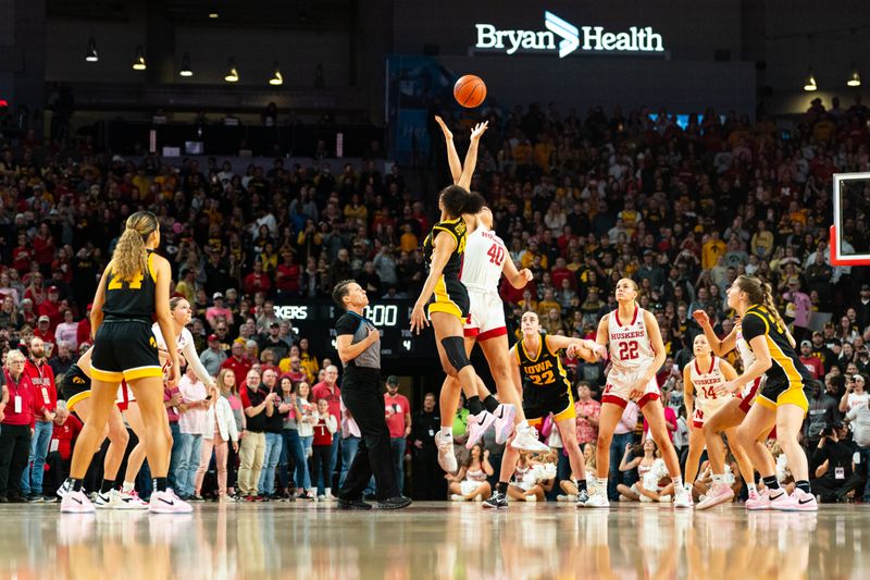 Feb 11, 2024; Lincoln, Nebraska, USA; Iowa Hawkeyes forward Hannah Stuelke (45) and Nebraska Cornhuskers center Alexis Markowski (40) jump for the opening tipoff at Pinnacle Bank Arena. Mandatory Credit: Dylan Widger-USA TODAY Sports