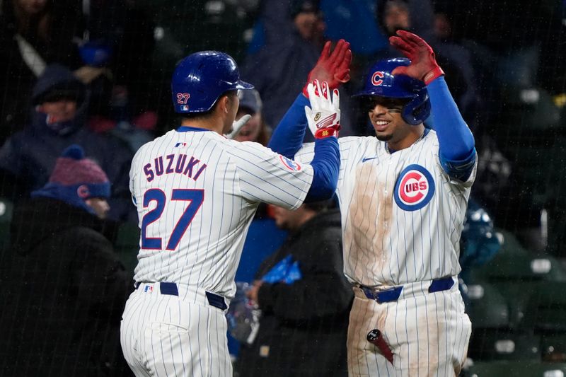 Apr 3, 2024; Chicago, Illinois, USA; Chicago Cubs right fielder Seiya Suzuki (27) is greeted by third baseman Christopher Morel (5) after hitting a home run against the Colorado Rockies during the fifth inning at Wrigley Field. Mandatory Credit: David Banks-USA TODAY Sports