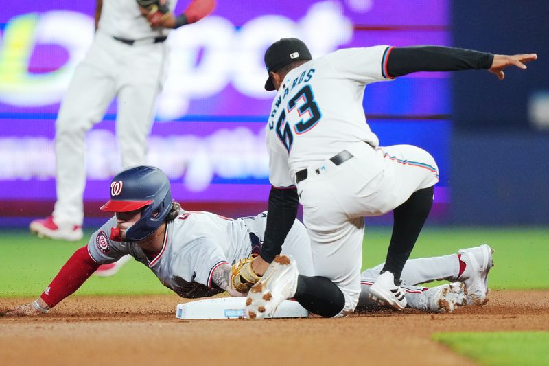 Sep 3, 2024; Miami, Florida, USA;  Washington Nationals right fielder Dylan Crews (3) gets caught stealing second base by Miami Marlins shortstop Xavier Edwards (63) in the first inning at loanDepot Park. Mandatory Credit: Jim Rassol-Imagn Images.