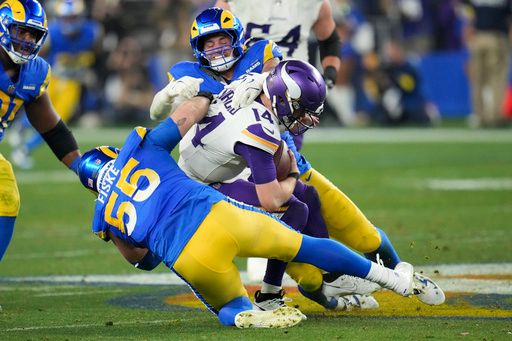 Los Angeles Rams defensive tackle Braden Fiske (55) and Michael Hoecht (97) sack Minnesota Vikings quarterback Sam Darnold (14) during the second half of an NFL wild card playoff football game, Monday, Jan. 13, 2025, in Glendale, Ariz. (AP Photo/Ross D. Franklin )