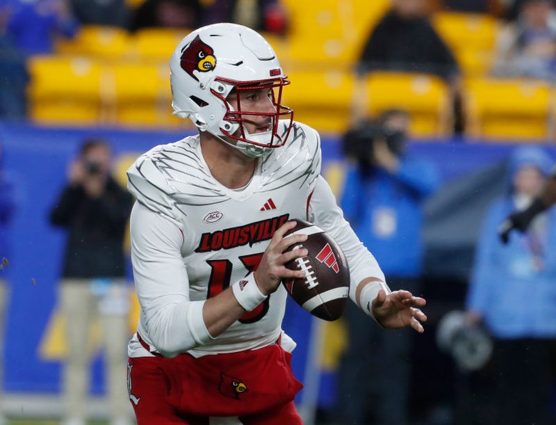 Oct 14, 2023; Pittsburgh, Pennsylvania, USA; Louisville Cardinals quarterback Jack Plummer (13) scrambles with the ball against the Pittsburgh Panthers during the first quarter at Acrisure Stadium. Mandatory Credit: Charles LeClaire-USA TODAY Sports