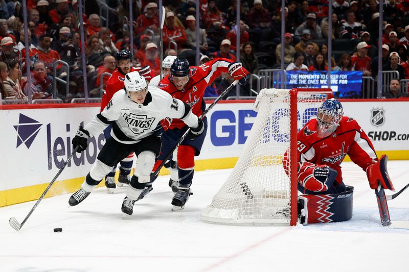 Nov 17, 2025; Washington, District of Columbia, USA; Los Angeles Kings center Alex Turcotte (15) skates with the puck against behind Washington Capitals goaltender Charlie Lindgren (79) as Capitals defenseman John Carlson (74) chases during the second period at Capital One Arena. Mandatory Credit: Geoff Burke-Imagn Images