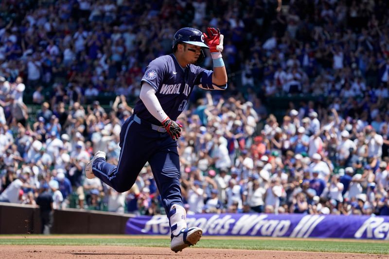 Jul 5, 2024; Chicago, Illinois, USA; Chicago Cubs outfielder Seiya Suzuki (27) gestures after hitting a two-run home run against the Los Angeles Angels during the first inning at Wrigley Field. Mandatory Credit: David Banks-USA TODAY Sports