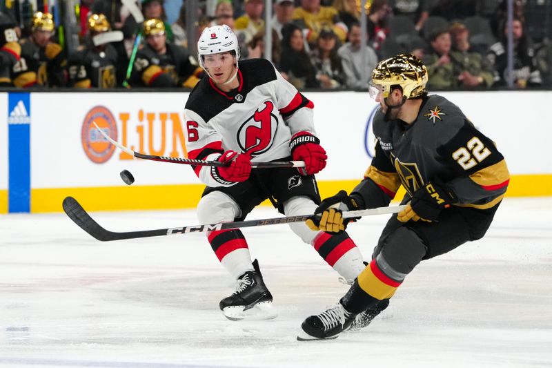 Mar 17, 2024; Las Vegas, Nevada, USA; New Jersey Devils defenseman John Marino (6) lifts the puck over the stick of Vegas Golden Knights right wing Michael Amadio (22) during the second period at T-Mobile Arena. Mandatory Credit: Stephen R. Sylvanie-USA TODAY Sports