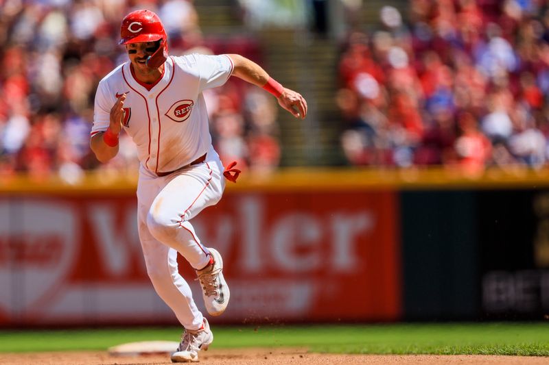 Jun 9, 2024; Cincinnati, Ohio, USA; Cincinnati Reds designated hitter Spencer Steer (7) scores on hit by third baseman Santiago Espinal (not pictured) in the seventh inning against the Chicago Cubs at Great American Ball Park. Mandatory Credit: Katie Stratman-USA TODAY Sports