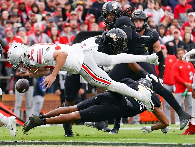 Oct 14, 2023; West Lafayette, Indiana, USA;  Purdue Boilermakers defensive back Markevious Brown (1) forces a fumble from Ohio State Buckeyes quarterback Devin Brown (33) during the first half at Ross-Ade Stadium. Mandatory Credit: Robert Goddin-USA TODAY Sports