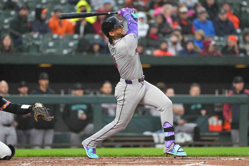 May 10, 2024; Baltimore, Maryland, USA; Arizona Diamondbacks second baseman Ketel Marte (4) hits a solo home run in the third inning against the Baltimore Orioles at Oriole Park at Camden Yards. Mandatory Credit: Mitch Stringer-USA TODAY Sports