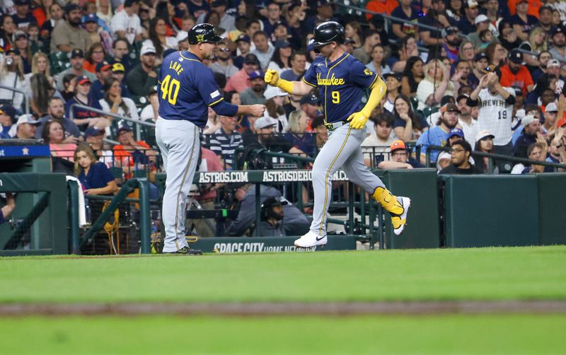 May 17, 2024; Houston, Texas, USA; Milwaukee Brewers first baseman Jake Bauers (9) celebrates third base coach Jason Lane (40) after hitting a home run against the Houston Astros in the second inning at Minute Maid Park. Mandatory Credit: Thomas Shea-USA TODAY Sports