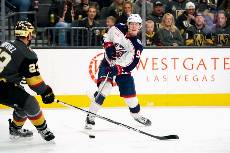 Mar 19, 2023; Las Vegas, Nevada, USA; Columbus Blue Jackets center Kent Johnson (91) passes the puck against Vegas Golden Knights defenseman Alec Martinez (23) during the third period at T-Mobile Arena. Mandatory Credit: Lucas Peltier-USA TODAY Sports