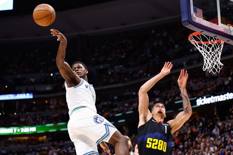 DENVER, COLORADO - MAY 19: Anthony Edwards #5 of the Minnesota Timberwolves passes the ball against Michael Porter Jr. #1 of the Denver Nuggets during the third quarter in Game Seven of the Western Conference Second Round Playoffs at Ball Arena on May 19, 2024 in Denver, Colorado. NOTE TO USER: User expressly acknowledges and agrees that, by downloading and or using this photograph, User is consenting to the terms and conditions of the Getty Images License Agreement. (Photo by C. Morgan Engel/Getty Images)