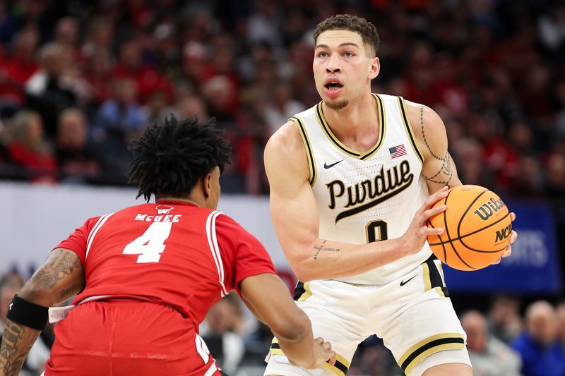 Mar 16, 2024; Minneapolis, MN, USA; Purdue Boilermakers forward Mason Gillis (0) controls the ball as Wisconsin Badgers guard Kamari McGee (4) defends during the first half at Target Center. Mandatory Credit: Matt Krohn-USA TODAY Sports