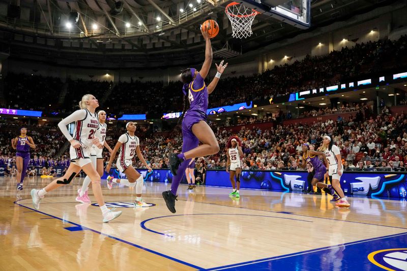 Mar 10, 2024; Greensville, SC, USA; LSU Lady Tigers guard Aneesah Morrow (24) on a fast break layup against the South Carolina Gamecocks during the first half at Bon Secours Wellness Arena. Mandatory Credit: Jim Dedmon-USA TODAY Sports