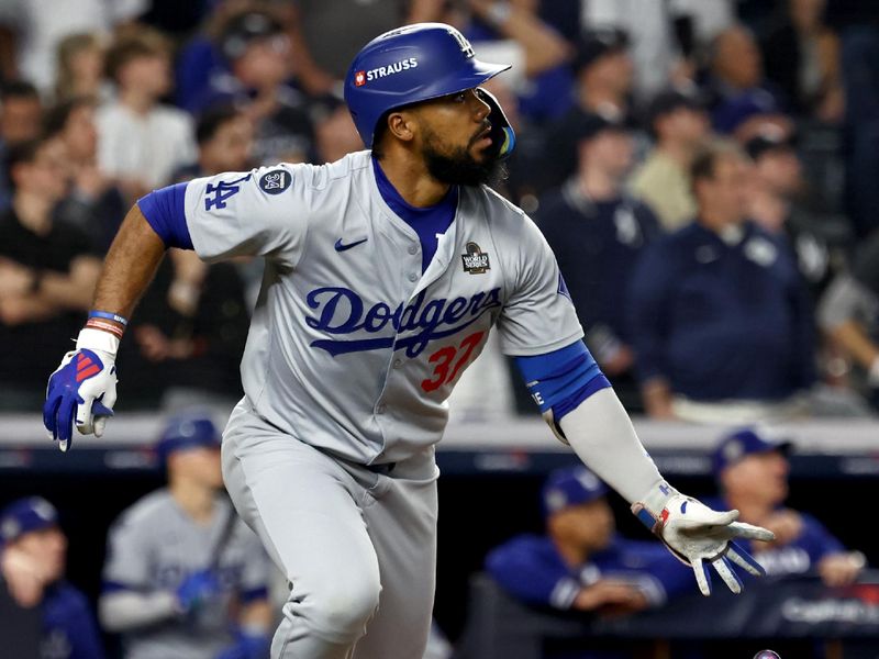 Oct 30, 2024; New York, New York, USA; Los Angeles Dodgers outfielder Teoscar Hernandez (37) hits a two-RBI double during the fifth inning against the New York Yankees in game five of the 2024 MLB World Series at Yankee Stadium. Mandatory Credit: Vincent Carchietta-Imagn Images