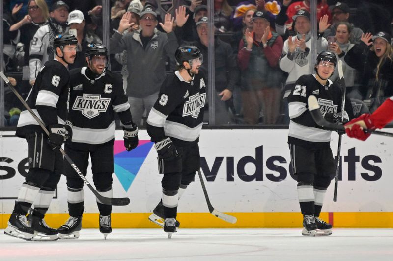 Nov 16, 2024; Los Angeles, California, USA; Los Angeles Kings right wing Adrian Kempe (9) celebrates an empty net goal on a pass from center Anze Kopitar (11) in the third period against the Detroit Red Wings at Crypto.com Arena. Mandatory Credit: Jayne Kamin-Oncea-Imagn Images