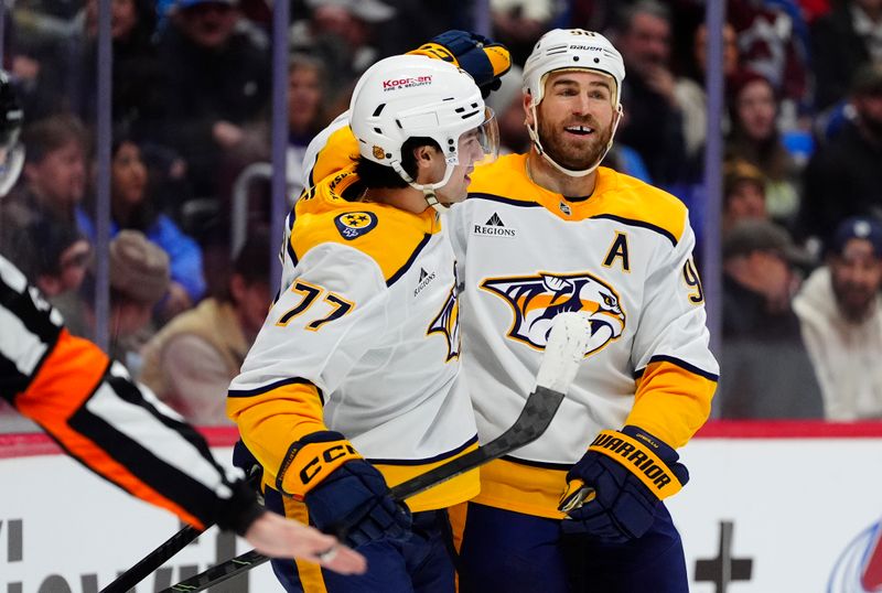 Jan 16, 2026; Denver, Colorado, USA; Nashville Predators center Ryan O'Reilly (90) and right wing Luke Evangelista (77) celebrate a goal scored in the first period against the Colorado Avalanche at Ball Arena. Mandatory Credit: Ron Chenoy-Imagn Images
