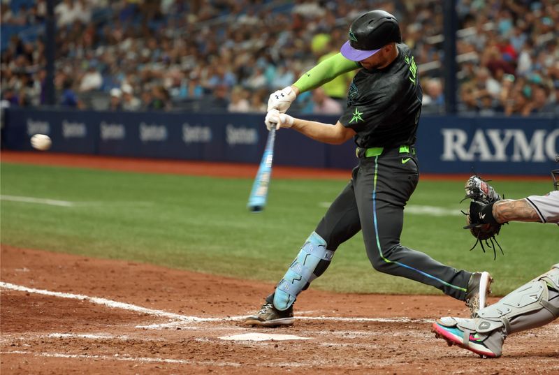 Aug 17, 2024; St. Petersburg, Florida, USA; Tampa Bay Rays first baseman Brandon Lowe (8) hits a two-run home run against the Arizona Diamondbacks during the sixth inning at Tropicana Field. Mandatory Credit: Kim Klement Neitzel-USA TODAY Sports