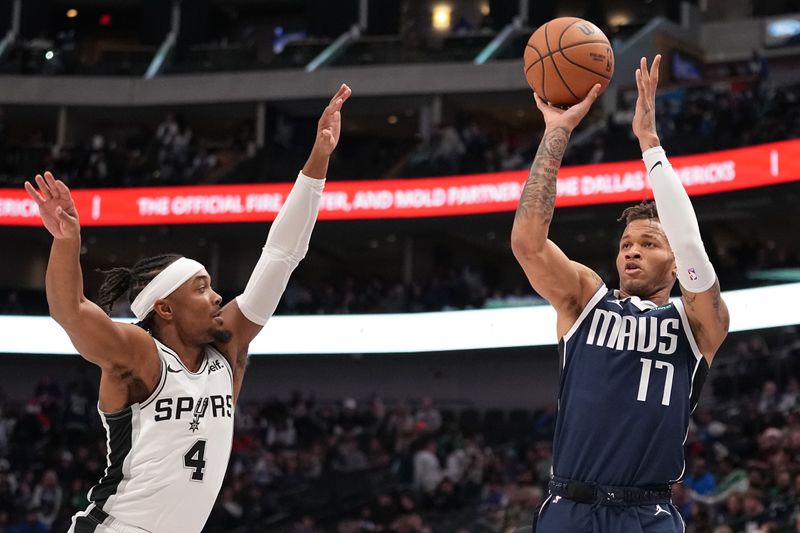 DALLAS, TEXAS - DECEMBER 23: Dexter Dennis #17 of the Dallas Mavericks shoots as Devonte' Graham #4 of the San Antonio Spurs defends during the second half at American Airlines Center on December 23, 2023 in Dallas, Texas. NOTE TO USER: User expressly acknowledges and agrees that, by downloading and or using this photograph, User is consenting to the terms and conditions of the Getty Images License Agreement. (Photo by Sam Hodde/Getty Images)