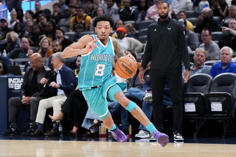 INDIANAPOLIS, INDIANA - OCTOBER 17: Nick Smith Jr. #8 of the Charlotte Hornets dribbles the ball in the first quarter against the Indiana Pacers during a preseason game at Gainbridge Fieldhouse on October 17, 2024 in Indianapolis, Indiana. NOTE TO USER: User expressly acknowledges and agrees that, by downloading and or using this photograph, User is consenting to the terms and conditions of the Getty Images License Agreement. (Photo by Dylan Buell/Getty Images)