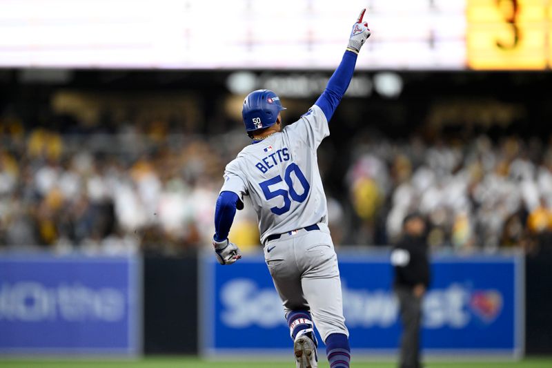 Oct 9, 2024; San Diego, California, USA; Los Angeles Dodgers shortstop Mookie Betts (50) celebrates after hitting a home run in the first inning against the San Diego Padres during game four of the NLDS for the 2024 MLB Playoffs at Petco Park.  Mandatory Credit: Denis Poroy-Imagn Images